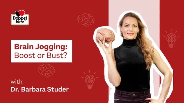 A woman holds a model of a brain, smiling confidently. The text overlay reads "Brain Jogging: Boost or Bust?" along with the name Dr. Barbara Studer. The background features a mix of solid colors and brain icons. The overall theme suggests exploring cognitive enhancement techniques.